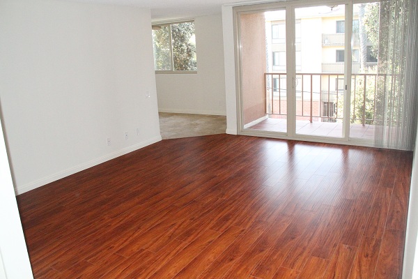 Large Living Room with hardwood floor leading to ocean view balcony Large Living Room with hardwood floor leading to ocean view balcony